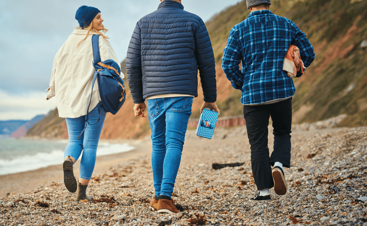 Trio walking on beach in winter